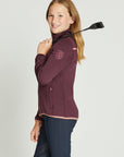Girl wearing maroon athletic top with pink trim at the sweater and the bottom.