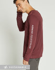 Man wearing maroon Asmar Equestrian long-sleeve riding shirt and grey colored pants.