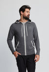 Men wearing grey hooded sweater with white trim on hood and pockets.