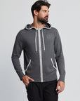 Men wearing grey hooded sweater with white trim on hood and pockets.